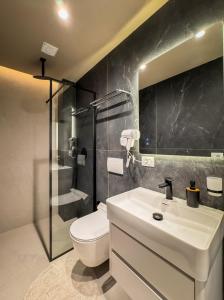 a bathroom with a sink and a toilet and a shower at All Seasons Apartments - Free Parking & City Center in Shkodër +81 photos