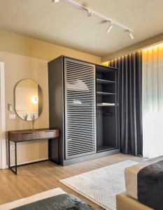 a bedroom with a dressing table and a mirror at All Seasons Apartments - Free Parking & City Center in Shkodër