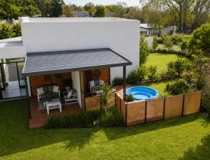 a backyard with a swimming pool and a house at 4 Lulworth in Johannesburg