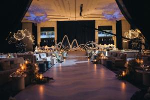 a banquet hall with white tables and chairs and lights at Gulf Executive Residence in Manama +67 photos