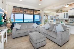 a living room with two couches and a view of the ocean at Super Beachfront Condo Ground Level on Sandy Beach in Puerto Peñasco