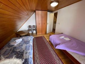 a bedroom with two beds and a table and chairs at Balkan Vibe Apartments in Žabljak
