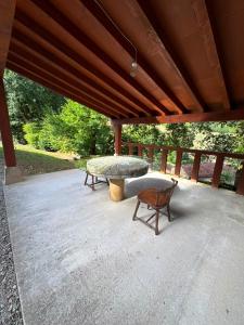 a patio with a table and a bench on it at Finca La Sierra in Abionzo