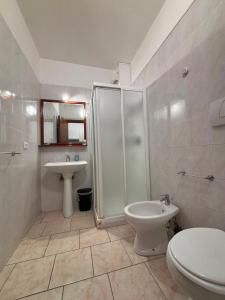 a bathroom with a shower and a toilet and a sink at Garden Residence in Quingentole