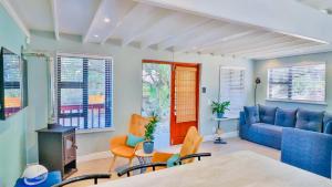 a living room with a blue couch and chairs at The Fisherman's LAB Cabin in Hermanus