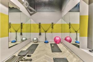a fitness room with a gym with exercise equipment at One Thibault Hotel - Sea View Studio - Near CTICC & V&A Waterfront in Cape Town