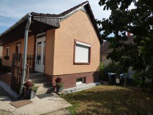 a small house with a window and a porch at Kovács Vendégház in Zalaegerszeg +7 photos