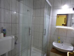 a bathroom with a shower and a sink at Kovács Vendégház in Zalaegerszeg