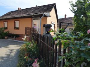 a house with a fence in front of it at Kovács Vendégház in Zalaegerszeg