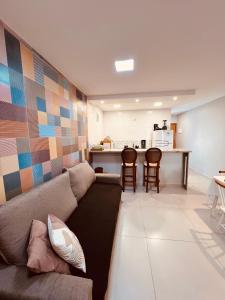 a living room with a couch and a kitchen at Recanto Serra e Mar in Angra dos Reis