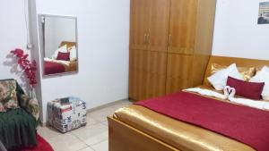 a bedroom with a large bed and a mirror at Suites in Domingos Martins
