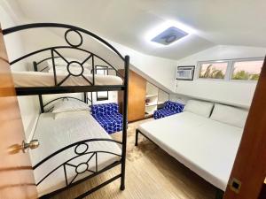 a room with two bunk beds and a door at J&D Fully-Aircon 400mbps Parking WiFi 6pax in Canaman