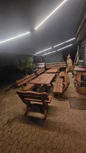 a row of wooden picnic tables in a building at Ferienwohnung Riesling in Burg +2 photos