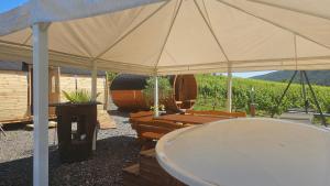 a large tent with chairs and a bath tub at Camping Schlaffass Odin in Burg