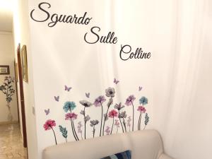 a bedroom with a white curtain with purple flowers and butterflies at Sguardo sulle colline del Chianti Scandicci Firenze in Scandicci