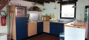 a kitchen with a refrigerator and a sink at Dix doré in Blaimont