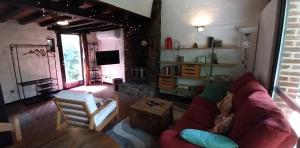 a living room with a couch and a fireplace at Dix doré in Blaimont