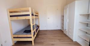 a room with two bunk beds and a closet at Ferienhaus Licht-Blick 9 in Wiltingen