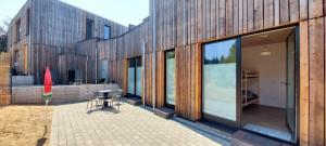 a building with a patio with a table and chairs at Ferienhaus Licht-Blick 9 in Wiltingen