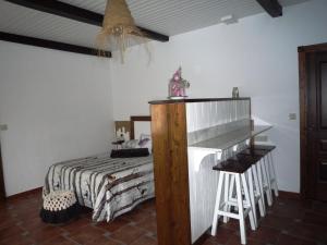 a bedroom with a bed and a table and stool at Albergue-Hostel Casa da Gandara in Boimorto +17 photos