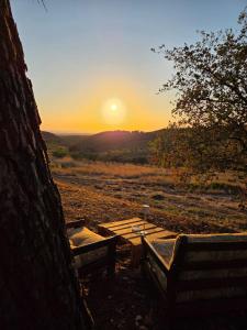 a picnic table with the sunset in the background at Podere Ortacavoli in Terriccio