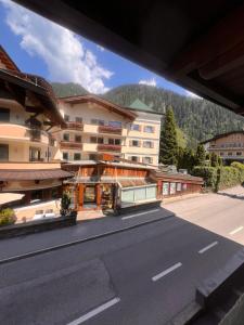 a view from a balcony of a building on a street at edelweiss lounge restaurant hotel pizza cafe billard gasthof in Mayrhofen