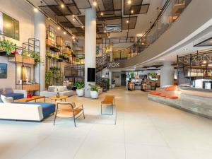 a lobby of a store with couches and tables at ibis Sao Paulo Barra Funda in São Paulo