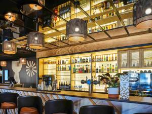 a bar with a lot of bottles of alcohol at Mercure Paris Gare De Lyon TGV in Paris