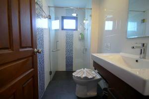 a bathroom with a toilet and a sink and a shower at Chaba Villa at Had Yao Beach in Had Yao Beach +15 photos