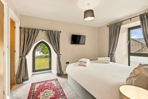 a bedroom with a large bed and a window at 5 Old Templars - North East Escapes in Spittal