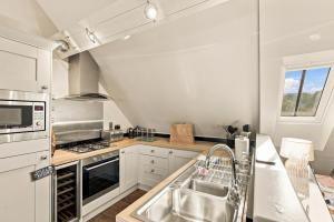 a kitchen with a sink and a stove at 5 Old Templars - North East Escapes in Spittal