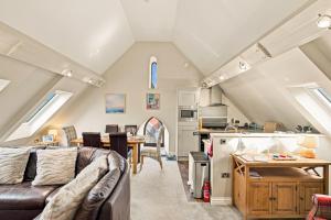 a living room and kitchen with a couch and a table at 5 Old Templars - North East Escapes in Spittal +17 photos