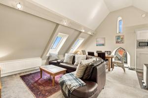 a living room with a couch and a table at 5 Old Templars - North East Escapes in Spittal