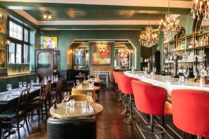 a restaurant with tables and chairs and a bar at The Bedford Balham - Live Music Venue in London +26 photos