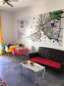 a living room with a couch and a table and a map at Interno 10 in Siracusa