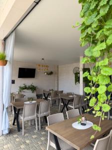 a restaurant with tables and chairs and a tv at Смерекова хата in Zatoka +70 photos