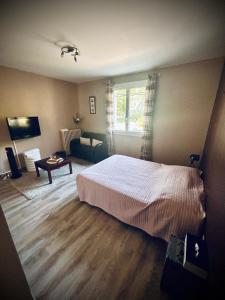 a bedroom with a bed and a living room at Maison Fleurie in Aubertin +17 photos
