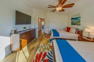 a bedroom with two beds and a flat screen tv at Pool & Yard Games! Group Retreat in La Quinta in La Quinta +36 photos