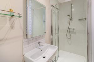 a white bathroom with a sink and a shower at 2 Bed in Bideford oc-32240 in Parkham +18 photos