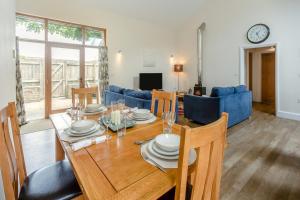 a dining room and living room with a table and chairs at 2 Bed in Bideford oc-32240 in Parkham