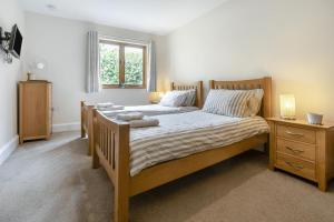 a bedroom with two beds and a window at 2 Bed in Bideford oc-32240 in Parkham