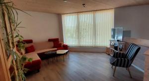 a living room with a couch and a table at Ferienhaus Licht-Blick 9 in Wiltingen