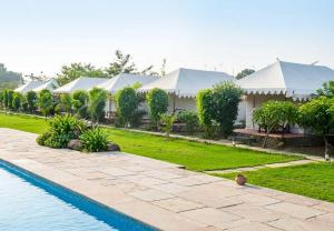 a view of a resort with a swimming pool at The Jungle Enclave Boho in Khilchipur