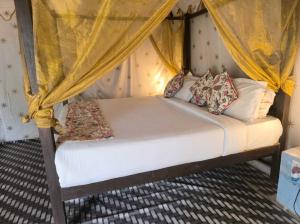 a bedroom with a bed with a canopy at The Jungle Enclave Boho in Khilchipur