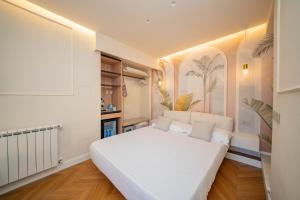 a bedroom with a large white bed in a room at Villa al Duomo Taormina - Suite & Rooms in Taormina +33 photos