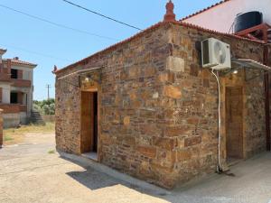 a brick building with a tv on the side of it at La Casa Nuova in Chios