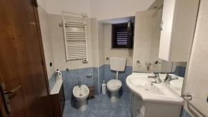 a bathroom with a sink and a toilet and a sink at Casa vacanze Donna Santa in San Marco dʼAlunzio +3 photos