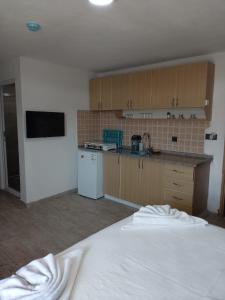 a kitchen with a white bed in a room at Fethiye Apart Otel in Fethiye