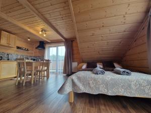 a bedroom with a bed in a room with wooden walls at Pokoje goscinne u Jozka in Chochołów