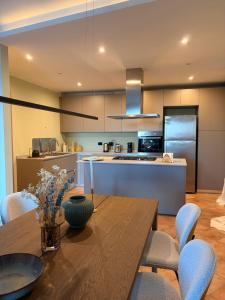 a kitchen and dining room with a wooden table at Liber Barbaresco House in Barbaresco